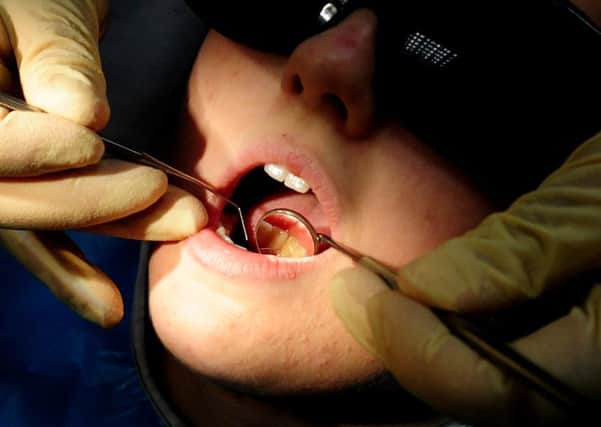 File photo dated 19/05/11 of an NHS dentist at work. The NHS will celebrate its 70th anniversary on Thursday 5th July 2018.